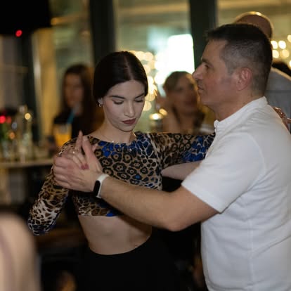 Salsa dance partners practicing synchronized Latin dance moves at Latin Grow studio in Xanthi