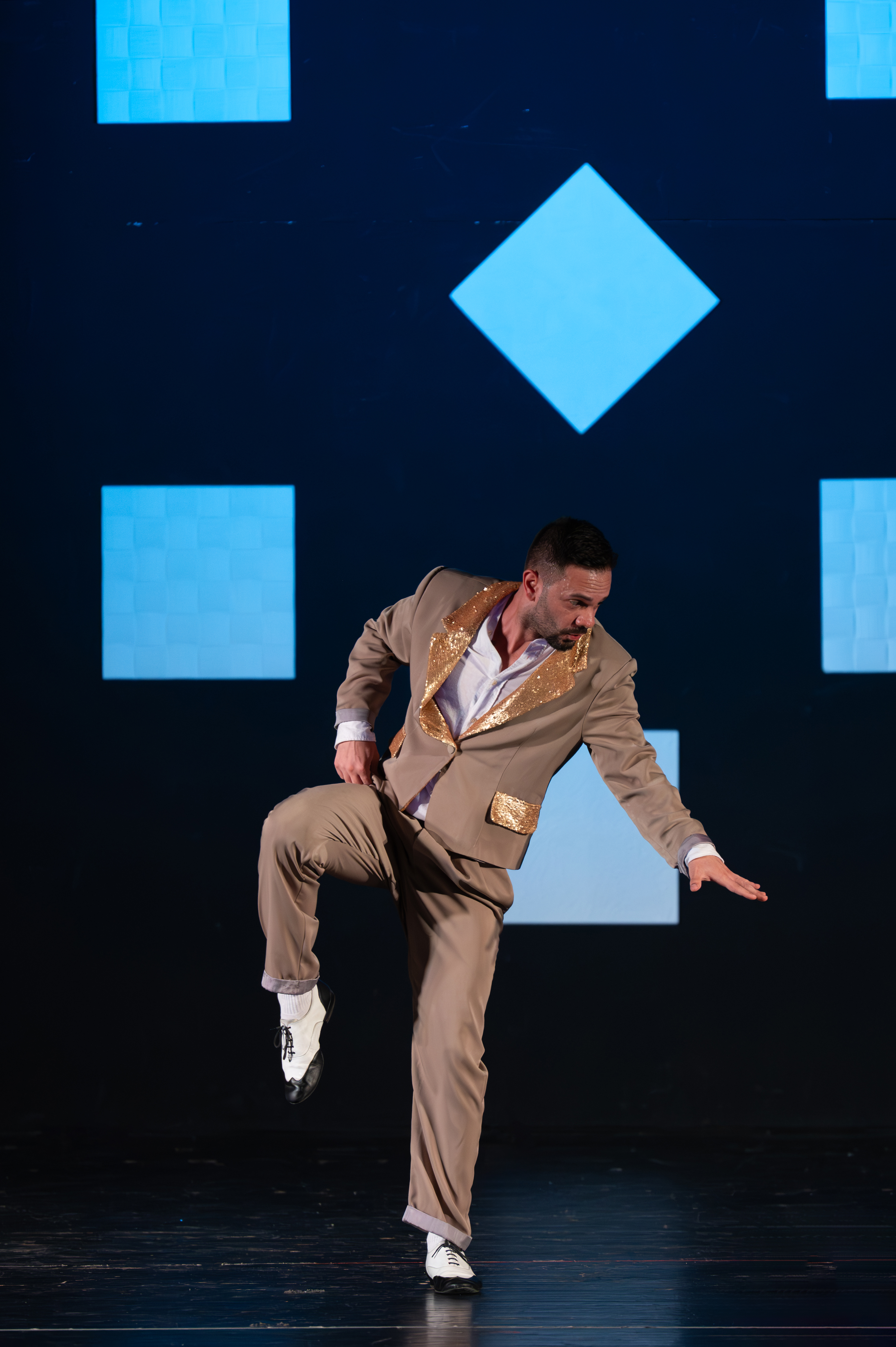 Professional Latin dance performer showcasing advanced salsa techniques at Latin Grow showcase event